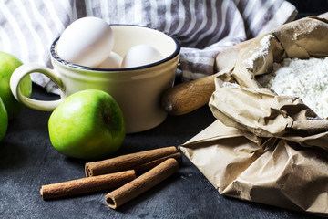 The ingredients for apple pie on a black background, selective focus, horizontal