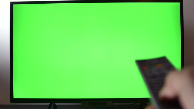 Right Handed Man Changing Channels On His Tv Set, Green Screen