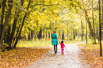 Obraz premium Mother with her baby. Mom and daughter in an autumn park