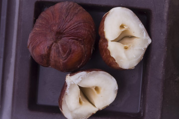 young forest nuts on top of the black solid chocolate close