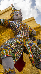 Obraz premium The special of giants statue with elephant trunk under golden pagoda of Emerald Buddha temple(Wat phra kaew) and Royal Grand Palace ,Bangkok,Thailand.