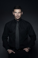 Fototapeta premium young business man in studio in black shirt
