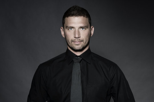 Young Business Man In Studio In Black Shirt