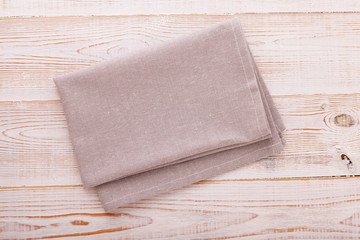 Napkin. Cloth napkin on white wooden background. Top view, mock up.
