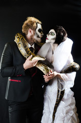 Dead face boy and girl with beautiful snake  