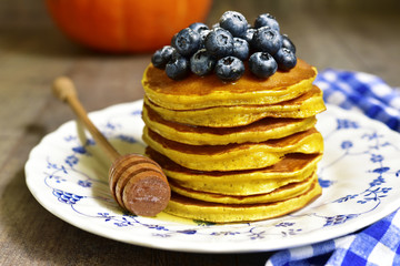 Pumpkin pancakes with fresh blueberry and honey.