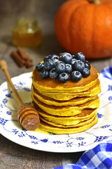 Pumpkin pancakes with fresh blueberry and honey.