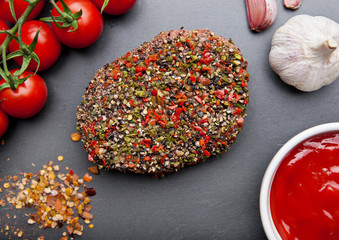 Beef raw steak with pepper and tomatoes on stone board
