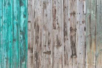 Wooden Palisade background. Close up of grey and green wood old fence panels texture
