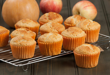 Homebaked Cupcakes In Paper Cases. Wooden Table. Pumpkins. Apple