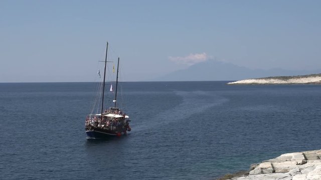 Junk sailboat passing by giola in Thassos Greece