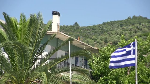 Greek flag in harbor skala kallirachi, Thassos Greece