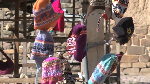 Chullos in the wind at a typical Peruvian market in Ollantaytambo