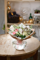 Obraz na płótnie Canvas glass vase with Mixed bouquet on wood table. beautiful fresh flowers still life.