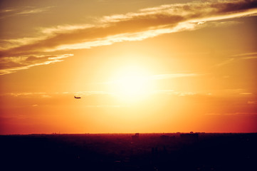 Airplane flying into the sun