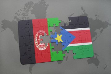 puzzle with the national flag of afghanistan and south sudan on a world map background.