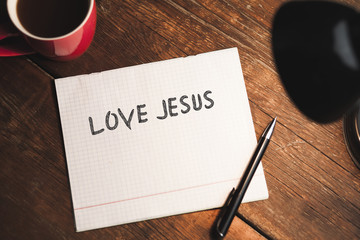 Love Jesus text on notebook