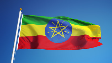 Ethiopian flag waving against clean blue sky, close up, isolated with clipping path mask alpha channel transparency