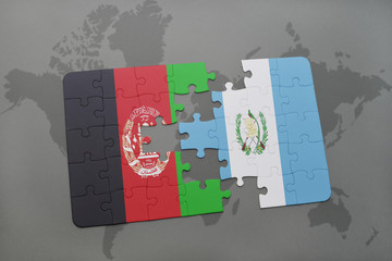 puzzle with the national flag of afghanistan and guatemala on a world map background.