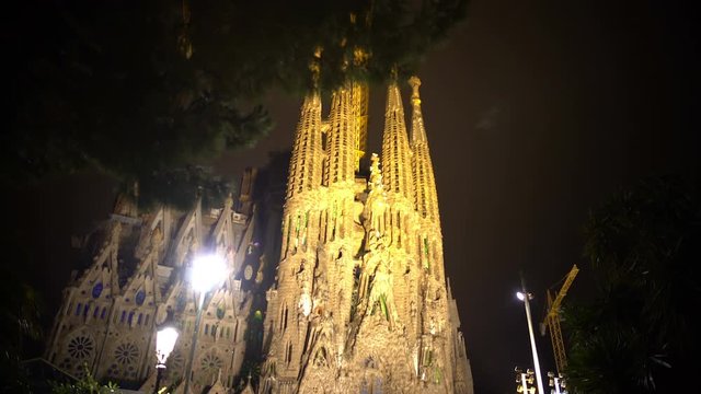 Group of tourists viewing Sagrada Familia church designed by Gaudi, Barcelona