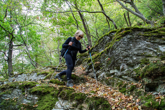 Senior woman nordic walking in nature