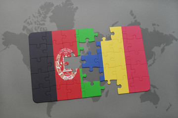 puzzle with the national flag of afghanistan and romania on a world map background.