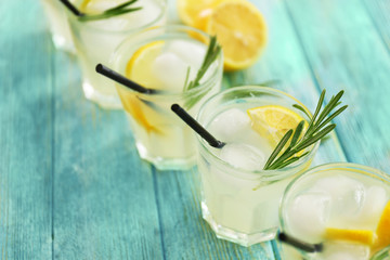 Cold fresh cocktails with lemon on wooden background