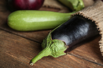 Fresh eggplants on wooden background
