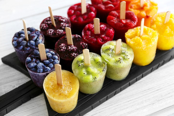 Tasty fruit ice-cream on cutting board