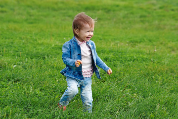  Baby girl walking on the grass (1 year old)