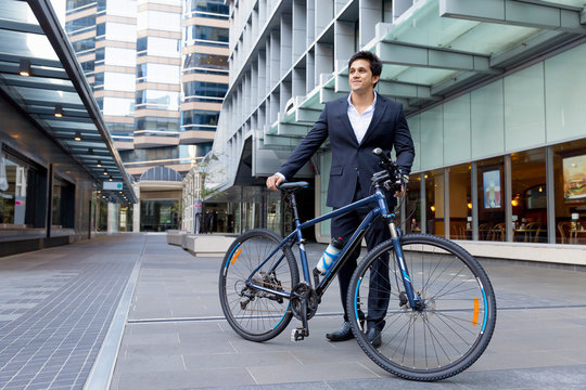 Successful businessman riding bicycle
