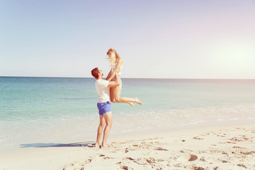 Happy couple  jumping on beach vacations