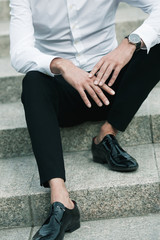 Luxurious and stylish concept. Rich young man sitting on marble