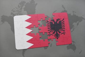 puzzle with the national flag of bahrain and albania on a world map background.
