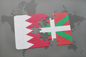 puzzle with the national flag of bahrain and basque country on a world map background.