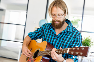 Man playing guitar in office