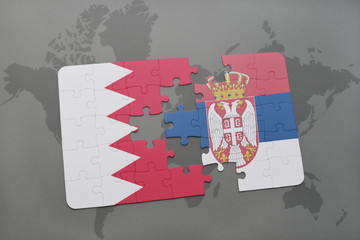 puzzle with the national flag of bahrain and serbia on a world map background.