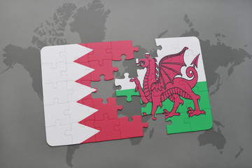 puzzle with the national flag of bahrain and wales on a world map background.