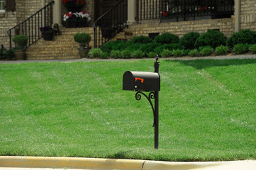mailbox in the green lawn in front of the house