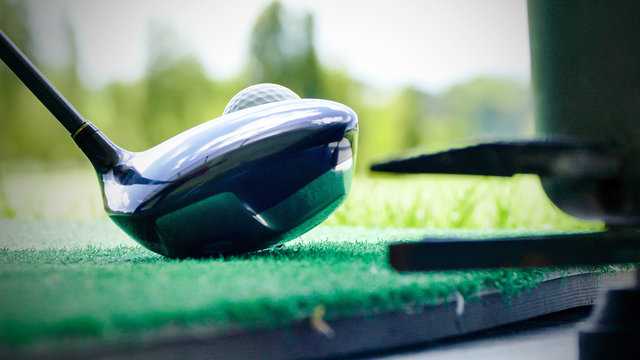 Golf Ball And Putter On Green Grass Of Course