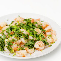 Fried shrimps with the greens. Easy seafood snack on white background close-up.