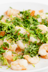 Fried shrimps with the greens. Easy seafood snack on white background close-up.