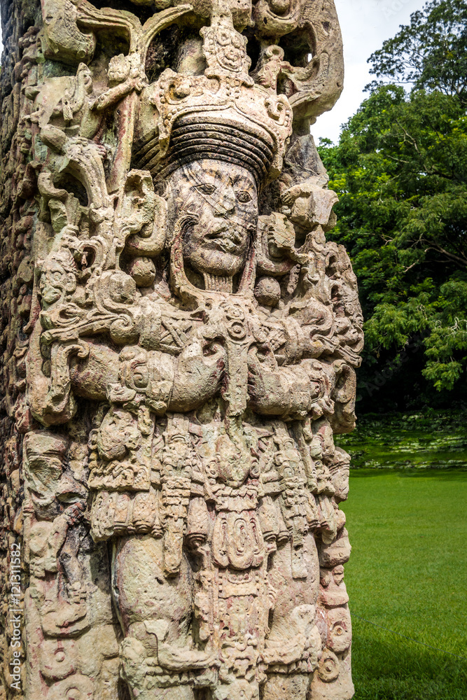 Wall mural detail of carved stela in mayan ruins - copan archaeological site, honduras