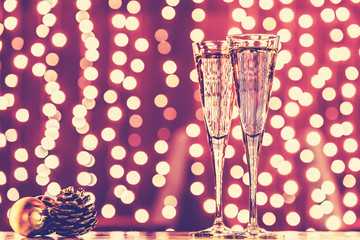 Two glasses of champagne with Christmas toys. Festive lights bok