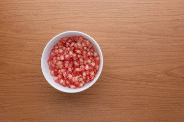 Ripe pomegranate fruit on wooden background
