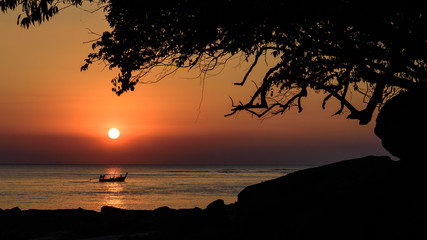 Silhouette fishing boat and sunset