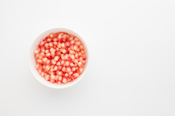 pomegranate and seeds on white background
