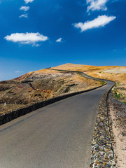 The road to the top of the mountain Mirador del Rio on background blue sky. Lanzarote. Canary Islands. Spain