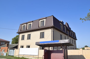 The house with plastic windows and a roof of corrugated sheet