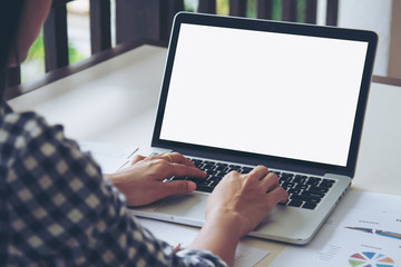 Business woman typing on keyboard laptop working on business report. The blank screen with copy space for your text or advertising content. Selective focus.